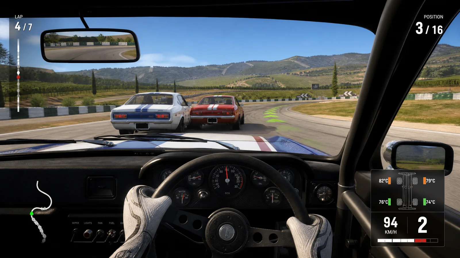 Cockpit touring-car gameplay on a vineyard circuit with lap, position and tyre-temperature HUD.